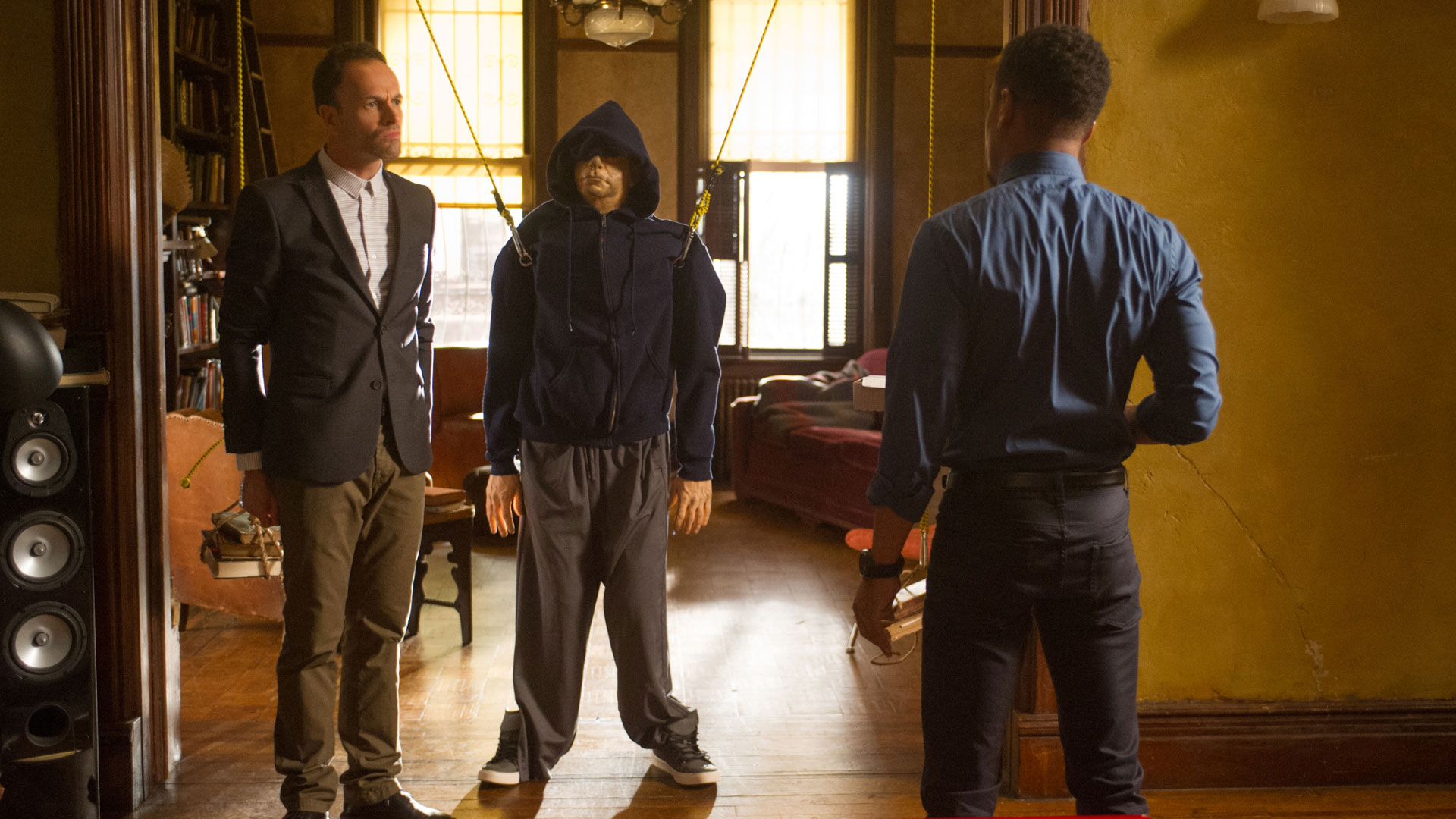 Jonny Lee Miller as Sherlock Holmes and Jon Michael Hill as Detective Marcus Bell