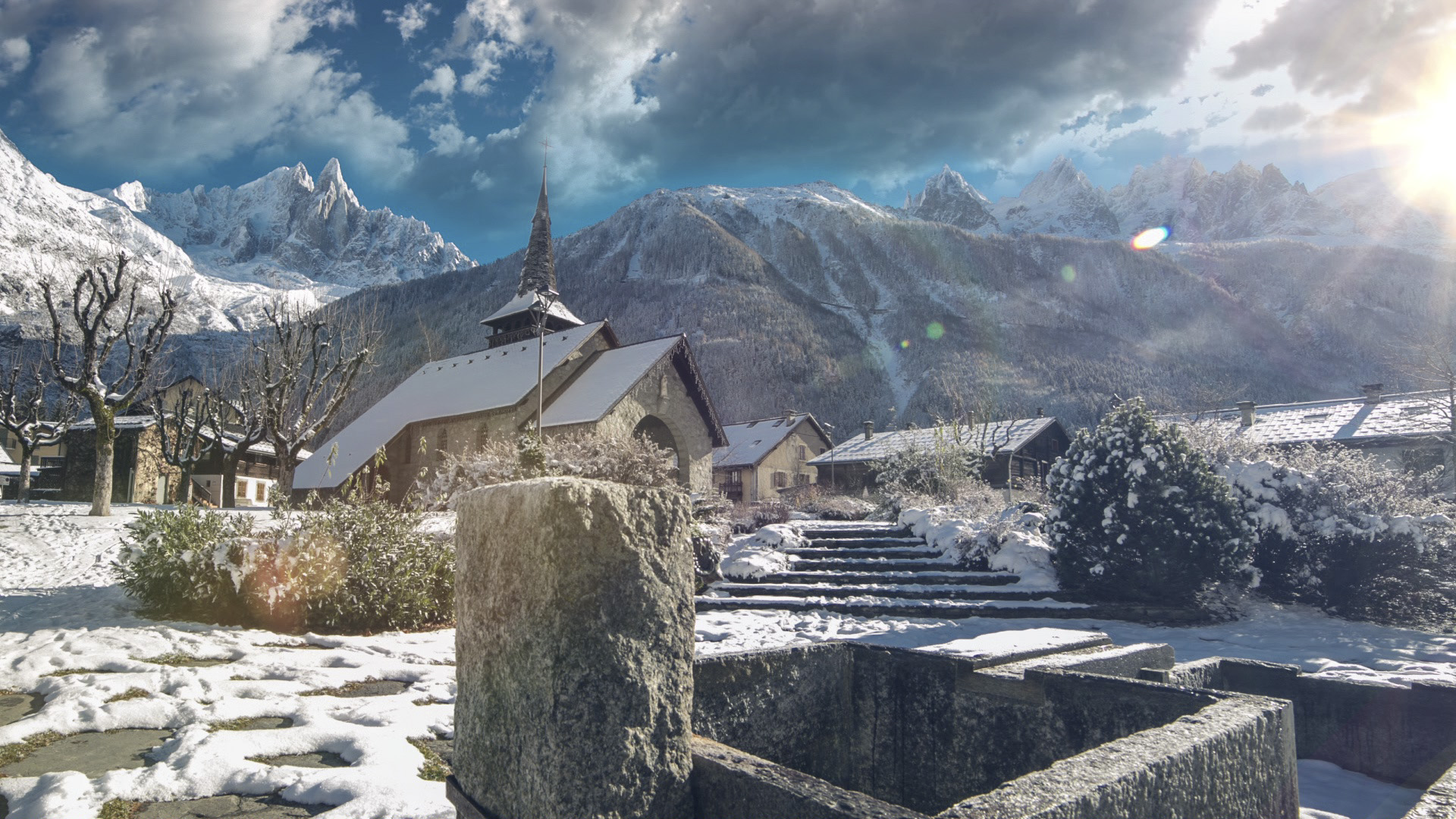 The teams travel through snow-capped mountains in Chamonix, France.