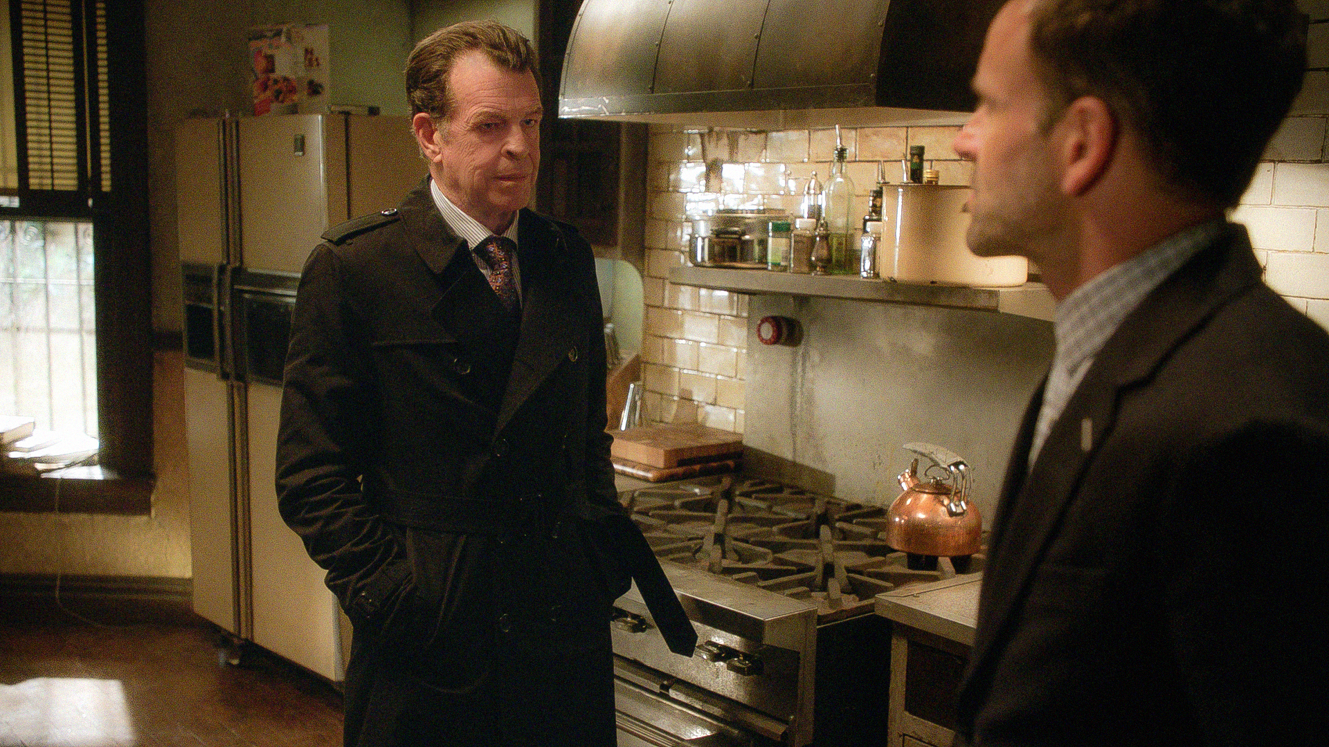 John Noble as Morland Holmes and Jonny Lee Miller as Sherlock Holmes