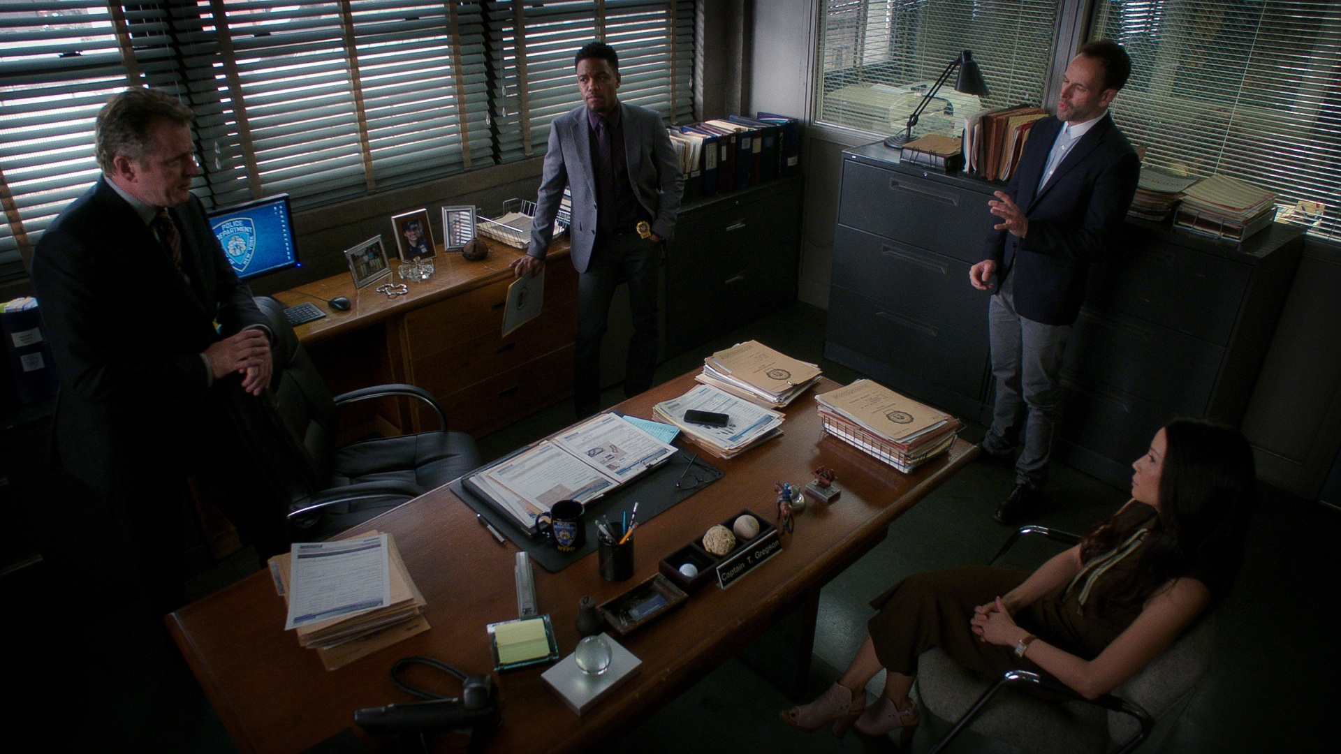 Aidan Quinn as Captain Thomas Gregson, Jon Michael Hill as Detective Marcus Bell, Jonny Lee Miller as Sherlock Holmes, and Lucy Liu as Dr. Joan Watson