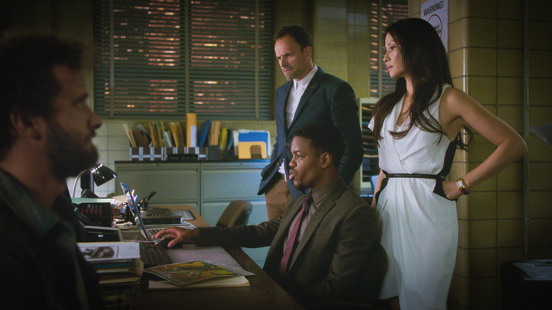 Jon Michael Hill as Detective Marcus Bell, Jonny Lee Miller as Sherlock Holmes, and Lucy Liu as Dr. Joan Watson
